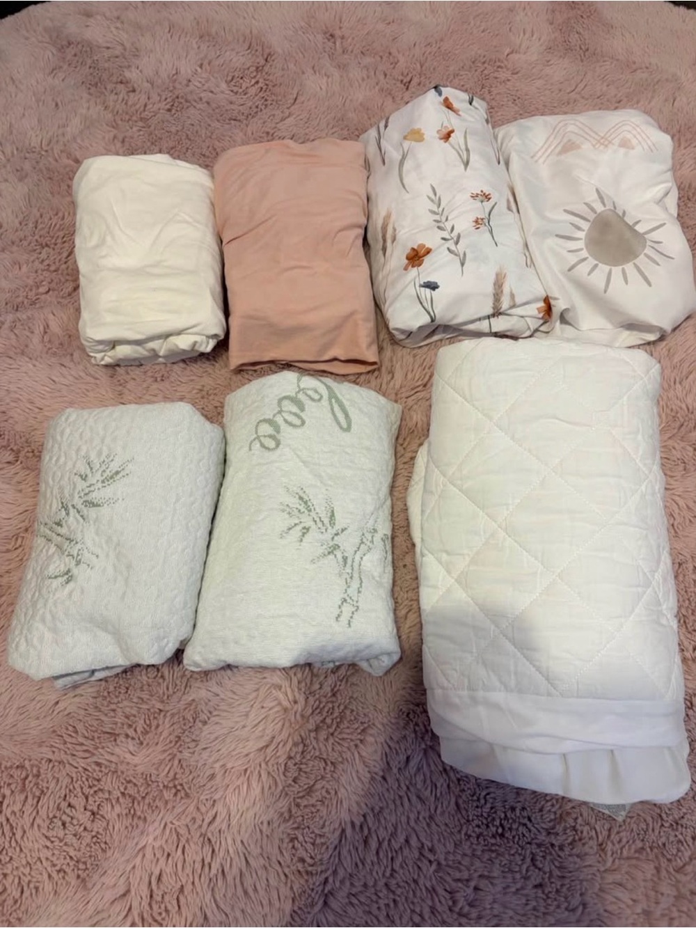 Set of standard crib sheets (4)and crib mattress protectors (3)